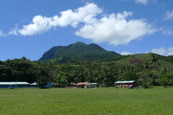 Delainabukelevu rising above Nabukelevu-ira village. Photo Leon Perrie, Te Papa